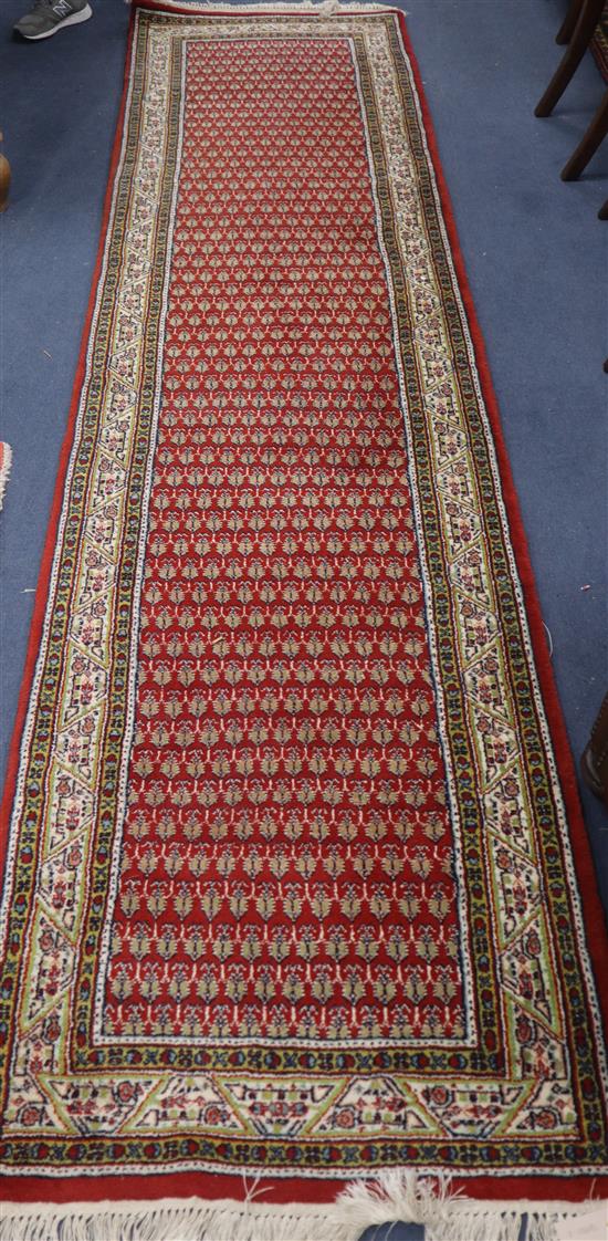 A Feraghan red ground runner 320 x 80cm